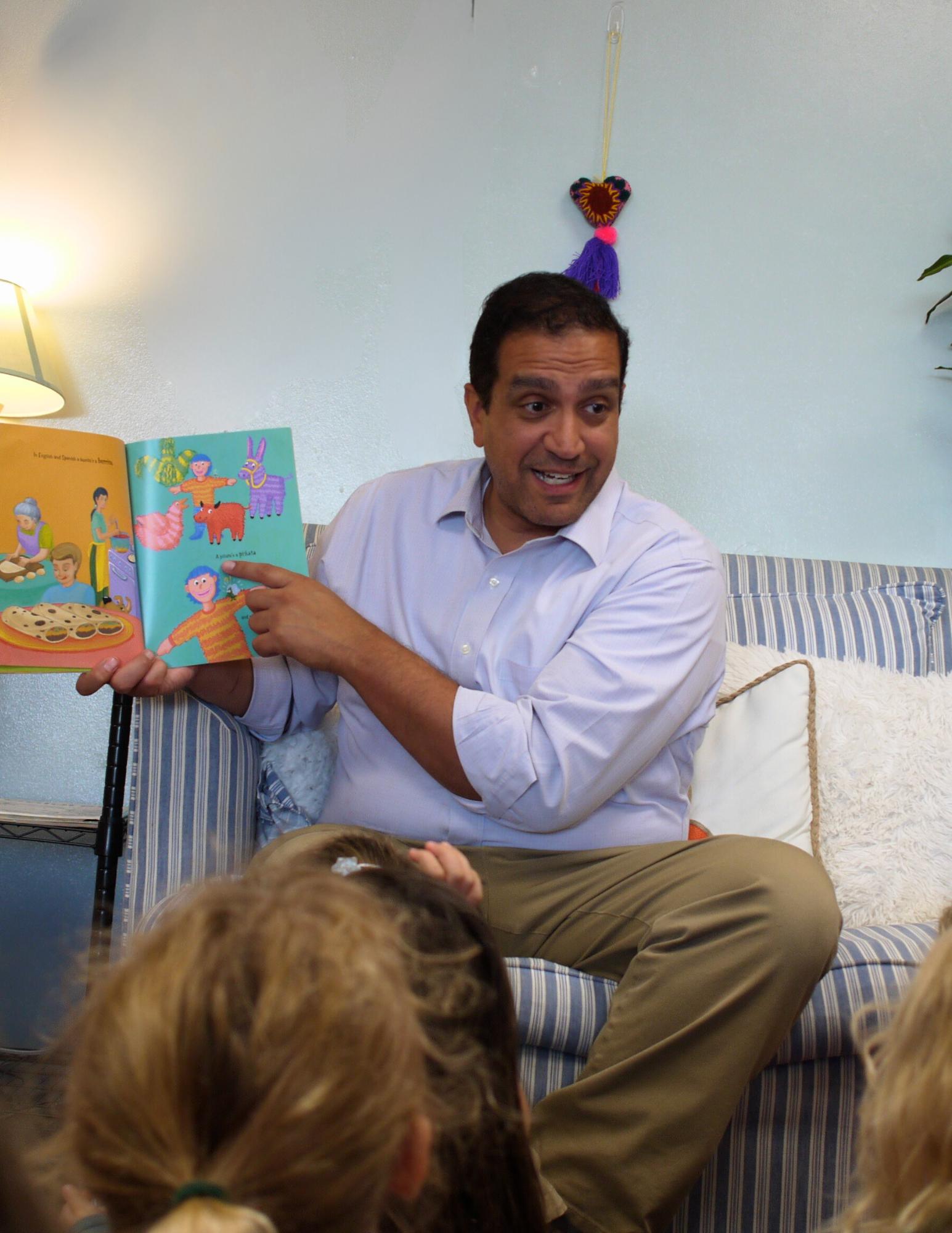 Mark reading a book in Spanish to the Pre-Kindergarten class.